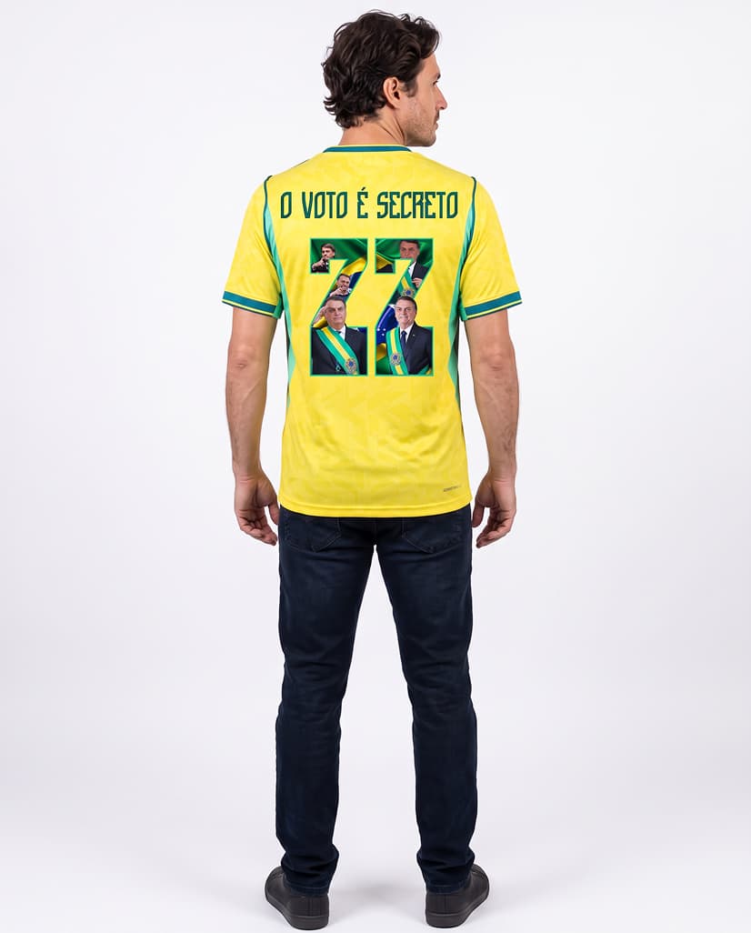 Homem de costas vestindo a camisa amarela com o número 22 e a frase “O voto é secreto”